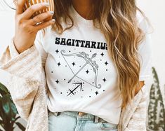 "This vintage minimalist look tee is a great birthday gift for any zodiac sign. Retro astrology gift for hippie, magic, celestial or boho aesthetic lovers. Zodiac signs and dates     ♑ Capricornus (Goat): December 22-January 19     ♒ Aquarius (Water Bearer): January 20-February 18     ♓ Pisces (Fish): February 19-March 20     ♈ Aries (Ram): March 21-April 19     ♉ Taurus (Bull): April 20-May 20     ♊ Gemini (Twins): May 21-June 21     ♋ Cancer (Crab): June 22-July 22     ♌ Leo (Lion): July 23-August 22     ♍ Virgo (Virgin): August 23-September 22     ♎ Libra (Balance): September 23-October 23     ♏ Scorpius (Scorpion): October 24-November 21     ♐ Sagittarius (Archer): November 22-December 21 SIZING: Most customers feel the shirts fit true to size.  This is a unisex shirt. The shirt is a r Retro Astrology, Aquarius Water Bearer, Aesthetic Lovers, Gemini Twins, Pisces Fish, Aries Ram, Astrology Gifts, Taurus Bull, December Birthday Gifts