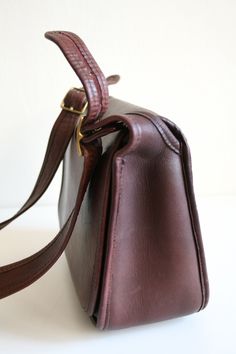 "Coach Bonnie Cashin Patricia bag in oxblood leather. This iconic Coach bag is high quality and authentic. The bag features a flap closure, exterior pocket, and small interior pocket with zipper. In good condition with aged patina and wear on piping and strap. Made in New York City, USA. height: 8.5\" length: 10\" depth: 4\" strap: 32-35\" message me with questions and stay in touch via Instagram @boxofhollyhocks Thanks for looking!" Contemporary Costumes, Bonnie Cashin, Oxblood Leather, Vintage Coach Bags, Basic Jewelry, Native American Turquoise, Classic Bags, Coach Bag, Vintage Coach