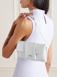 Proenza Schouler's '90s-inspired 'Flip' bag debuted on the label's Spring '24 runway. Defined by its soft pillowy structure, it's crafted from supple leather and has an adjustable shoulder strap. It opens up to dual compartments - one features zipped pockets for your cards and coins, while the other is sized to hold your phone and lipstick. White Baguette Bag With Dust Bag For Evening, White Baguette Bag For Evening With Dust Bag, White Luxury Baguette Bag For Evening, Luxury White Baguette Bag For Evening, White Flap Bag With Magnetic Closure For Evening, White Leather Flap Bag For Evening, Modern White Flap Bag For Evening, Modern White Baguette Bag For Evening, Rectangular Baguette Bag With Palladium Hardware