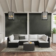 a living room with black and white furniture on the wooden floor, two lamps hanging from the ceiling