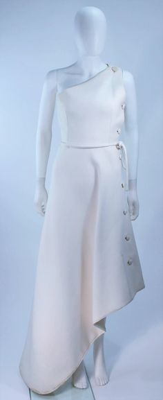 For Sale on 1stDibs - This Givenchy Haute Couture Gown is composed of a white wool and features an asymmetrical design with side button detail. In excellent vintage condition Givenchy Haute Couture, Haute Couture Gowns, Couture Gown, White Gown, White Gowns, Couture Gowns, Asymmetrical Design, Button Detail, Givenchy