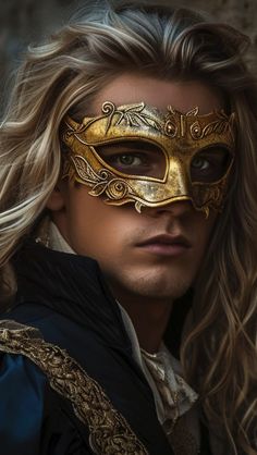 a man with long blonde hair wearing a gold masquerade and looking at the camera