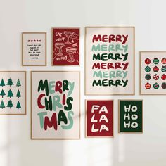 christmas cards displayed on the wall in various styles and colors, including red, green, white, and black