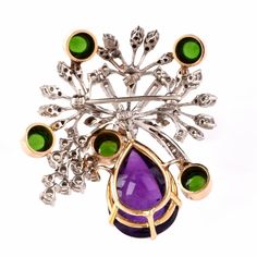 "This aesthetically alluring Retro vintage brooch pin is crafted in a solid 14K white and yellow gold, the latter applied to colored gemstones settings. It weighs 22.5 grams and measures 2 long x 1.9\" wide. This eye-catching Retro brooch is centered by one round diamond 0.78ct, complemented by some 55 round-faceted diamonds of varying sizes, 5 baguette diamonds and two marquise diamonds all approx. 3.10 cts H-I color, VS clarity approx. A prominent pear-shape amethyst cabochon 18.50 cts and 5 r Elegant Multi-stone Brooches For Formal Occasions, Elegant Diamond Multi-stone Brooch, Formal Multi-stone Brooch In Fine Jewelry Style, Formal Multi-stone Brooch Fine Jewelry, Formal Multi-stone Brooches In Fine Jewelry Style, Fine Jewelry Diamond Multi-stone Brooch, Fine Jewelry Diamond Multi-stone Brooches, Diamond Multi-stone Brooches In Fine Jewelry Style, Fine Jewelry White Gold Round Brooches