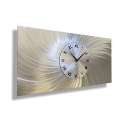 a metal clock mounted to the side of a wall with an abstract design on it