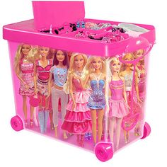 a pink plastic toy box filled with barbie dolls