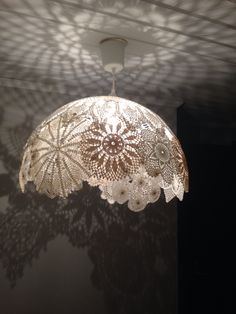 an intricately designed chandelier hangs from the ceiling in a dimly lit room