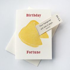 a couple of cards sitting on top of each other next to some type of paper