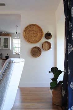 an image of a living room with three baskets on the wall