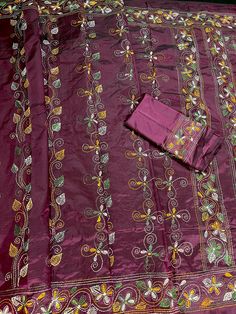 Gorgeous Burgundy color saree with handwoven Kantha stitch work in Multi Color Thread. The base of saree is in Burgundy color while the kantha work has been done in white. Please note - The edging on the pallu end is done by the weaver with the same kantha stitch work and not done with machine. Item: SareeColor : Burgundy and white color Base Fabric: Bangalori Silk Blouse piece : YesBlouse material: Bangalori Silk Work: Handloom, Kantha Work Fall & Edging (Yes/No) : Yes Occasion: Party, Festival Purple Unstitched Embroidered Silk Suit, Unstitched Purple Silk Suit With Embroidery, Purple Silk Unstitched Suit With Embroidery, Embroidered Purple Saree For Puja, Embroidered Tussar Silk Sets For Traditional Ceremonies, Silk Thread Saree For Puja And Festivals, Festival Silk Thread Saree For Puja, Purple Embroidered Sets For Traditional Ceremonies, Purple Cutdana Sets For Traditional Ceremonies