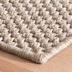 a close up view of a rug on a wooden floor with no one around it