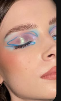 a woman with blue and pink eye makeup