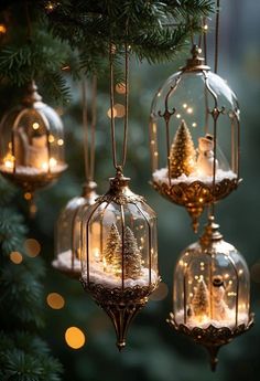 christmas ornaments hanging from a tree with lights in the shape of snow globes and trees