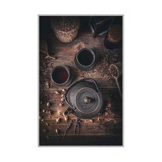 an overhead view of two tea cups on a wooden table with other items around it