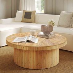 a living room with a couch, table and books on top of the coffee table