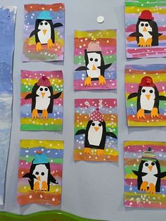 penguins are painted on colorful paper and hanging from the wall