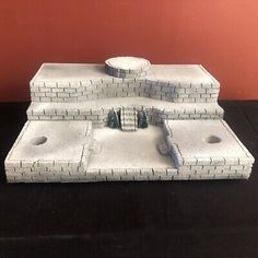 a model of a brick building with two holes in the front and one hole in the back