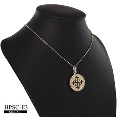 "circle shaped pendant curved with the symbol of the Kingdom of Jerusalem, which existed for almost two hundred years after the First Crusade the large cross is shown slightly \"potent\", but that is not always the case. The four smaller crosses are said to symbolize either the four books of the Gospel or the four directions in which the Word of Christ spread from Jerusalem. Alternatively, all five crosses can symbolize the five wounds of Christ during the Passion. This symbol is used in the fla Sterling Silver Amulet Necklace With Cross Pendant, White Gold Etched Pendant Jewelry, Symbolic Carved White Gold Jewelry, Sterling Silver Amulet Necklace With Carved Details, Silver Etched Cross Pendant Necklace, Engraved Cross Pendant Amulet Necklace, Engraved Cross Pendant Amulet Necklaces, White Gold Engraved Spiritual Necklace, Spiritual Engraved White Gold Necklace