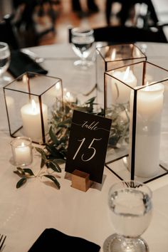 the table is set with candles and place cards