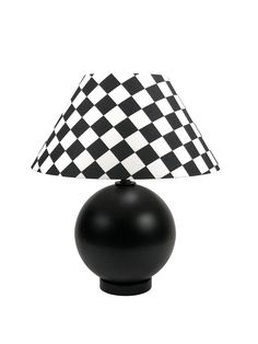 a black and white checkered lamp on a table