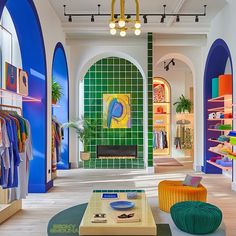 the interior of a clothing store with brightly colored walls and arches on either side of the room