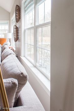 a living room filled with furniture next to a window