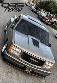 a silver truck parked on the side of a road