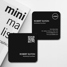 two business cards sitting next to each other on top of a white surface with qr code printed on it