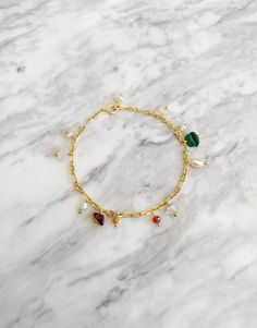 Beldevere. Inspired by the palace and gardens of Beldevere in Vienna. This bracelet is composed of 14K gold over sterling silver paperclip chain and carnelian, herkimer diamond, malachite, jasper, garnet gemstones and freshwater baroque pearls. Available in: ❉ 14K Yellow Gold vermeil ❉ 14K Rose Gold vermeil ❉ 925 Sterling Silver Not sure which length to buy? We can add a 1 inch extender chain. Just write a note at checkout! ❈ We send all our items with registered mail. ❉ Due to the organic nature of stones, there might be a slight variation in colour, size and shape. ✺ All items come packaged in a quality velvet pouch ready for gift giving. ✽ If you want to make a special order, just contact us! Elegant Gold Charm Bracelet With Natural Stones, Dangle Bracelet, Hippie Bracelets, Pink Box, Seed Bead Bracelets, Trombone, Pearl Gemstone, Herkimer Diamond, Garnet Gemstone