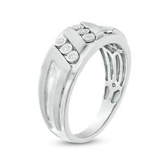 Update his attire with this sleek diamond ring. Crafted in sterling silver, this style features three slanted rows of diamonds - each artfully set to enhance size and radiance. Raised satin-finished details highlight the center design and lend dimension and depth to the polished shank. A look he'll enjoy wearing, this choice glistens with 1/10 ct. t.w. of diamonds and a brilliant buffed luster. Custom-made to fit his ring size. Sterling silver rings cannot be resized after purchase. Formal 14k White Gold Channel Set Ring, Modern Channel Set Diamond Promise Ring, Modern White Gold Channel Set Rings, Classic Diamond White Rings Channel Set, Classic Diamond White Rings With Channel Set, Modern Sterling Silver Channel Set Diamond Ring, Timeless Silver Channel Set Rings, Modern Diamond Ring With Accents For Anniversary, Modern Stackable Rings With Diamond Accents For Formal Occasions