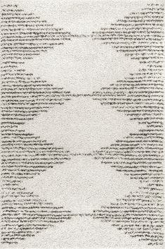 a white rug with lots of black and white writing on the bottom, in an abstract pattern