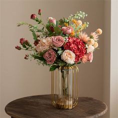 a vase filled with flowers on top of a wooden table