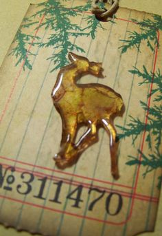 a metal keychain with a deer on it