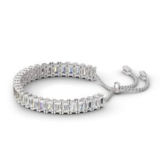 Illuminate her wrist with the lavish look of this gleaming sterling silver adjustable tennis bracelet. A row of emerald stones radiate optimal shimmer. Uniquely designed, each shimmering stone is set to appear extra large and more brilliant, creating twice the sparkle. Held together with a bolo clasp, this bracelet is a chic mix of glamour and elegance.Width: 5.6 mmHeight: 7.4 mmThickness: 4.1 mmMaterial: 925 SilverStone Type: Jeulia® StonePlating Color: SilverBracelet Size: 250 mm Dazzling Adjustable White Gold Tennis Bracelet, Adjustable Dazzling White Gold Tennis Bracelet, Adjustable Tennis Bracelet With Sparkling Stones, Silver Emerald Cut Tennis Bracelet, Luxury Adjustable Gemstone Tennis Bracelet, Emerald Cut Tennis Bracelet As Gift, Dazzling Adjustable Tennis Bracelet, Silver Emerald Cut Tennis Bracelet As Gift, Silver Emerald-cut Tennis Bracelet As Gift