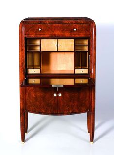 an old fashioned wooden desk with drawers on it's sides and two doors open