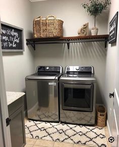 a washer and dryer sitting in a laundry room next to a shelf with baskets on it