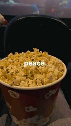 a bowl filled with popcorn sitting on top of a table