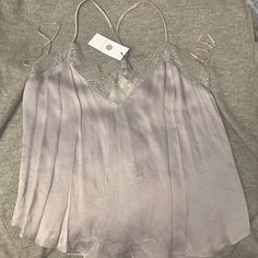 Super Cute Silver Tone Tank Top With A Lace Trim On Top. Has A Silky Feel To It But Is Thick Enough To Not Be See Through At All. The Brand It Socialite. It Is A Size M Brand New From Nordstrom. Tags Still Attached. Spring Cami Blouse For Night Out, Feminine Cami Top For Night Out, Spring Camisole Blouse For Night Out, Spring Lace Trim Top For Night Out, Feminine Cami Top For Date Night, Spring Camisole Top For Date Night, Elegant Cami Blouse With Lace Trim, Spring Sleeveless Blouse For Date Night, Sleeveless Blouse For Date Night In Spring