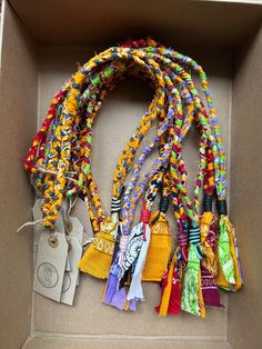 a box filled with lots of different colored ribbons