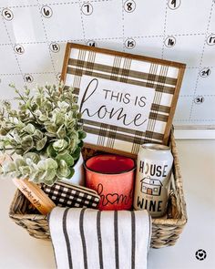 this is home gift basket with coffee mug, tea towel and other items in it