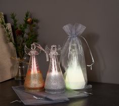 three small christmas ornaments in clear bags on a table