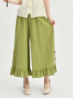 Elevate your wardrobe with our knotted buttons green wide-leg pants, inspired by traditional Cheongsam style with a modern twist. The knotted buttons and split cuffs add a touch of elegance and charm, while the shirring waist provides a comfortable and flattering fit. These pants are a versatile addition to your collection, perfect for both casual and formal occasions.  Please note that this product includes a pair of pants only.  Garment Size   	 		 			Size 			S 			M 			L 		 		 			Full Length Green Ankle-length Wide Leg Pants For Spring, Spring Wide Leg Pants With Button Cuffs, Chic Wide Leg Pants With Button Cuffs For Spring, Chic Green Bottoms With Buttons, Summer Wide-leg Bottoms With Button Cuffs, Summer Wide Leg Bottoms With Button Cuffs, Spring Green Wide-leg Culottes, Spring Wide Leg Pants With Buttons Ankle-length, Spring Wide-leg Pants With Button Cuffs