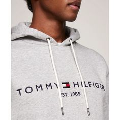 Stay comfortable and stylish with Tommy Hilfiger's Embroidered Logo Hoodie. Made with cotton, this fleece hoodie is designed for total comfort. Featuring the iconic Hilfiger signature logo and a convenient kangaroo pocket, this hoodie is the perfect addition to your wardrobe..Regular Fit: Tommy Hilfiger's Classic Pullover Hoodie made to fit comfortably..Size Medium Chest measures 44-1/2'.Model is wearing a size Medium.Drawstring hoodie for adjustable hood.Kangaroo pocket for added convenience.Classic Tommy Hilfiger embroidered logo.Cotton/polyester.Machine washable.Imported Hooded Sweatshirt With Logo Detail For Spring, Cotton Hoodie With Logo Detail Relaxed Fit, Cotton Hoodie With Logo In Relaxed Fit, Hooded Hoodie With Logo Detail For Spring, Spring Hooded Hoodie With Logo Detail, Sporty Logo Hoodie With Relaxed Fit, Spring Hoodie With Logo Detail, Sporty Relaxed Fit Hoodie With Logo, Logo Cotton Hoodie With Crew Neck