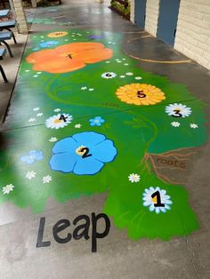 the floor has been painted with flowers and leaves on it, which reads leap 1