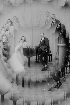 a black and white photo of a bride and groom playing the piano in front of their wedding party