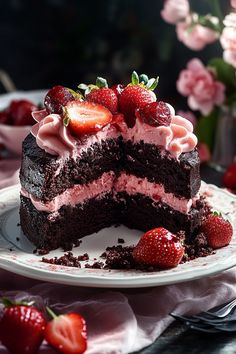 a piece of chocolate cake with strawberry frosting and strawberries on the top slice