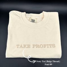 a white t - shirt with the words take profits printed on it