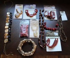 a table topped with lots of different types of necklaces