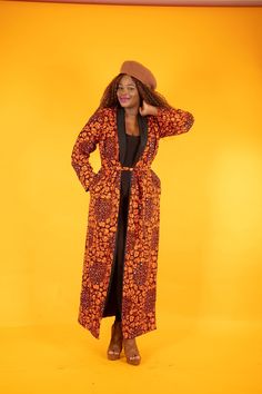 This African print Ankara jacket streamlines the profile with its longline cut. It's Black shawl lapel  is a simple way to elevate your look, with its open neckline and can be dressed up or down or with a matching palazzo trousers.  Part of IMOYE Collection Matching Pants/Trousers sold separately Details about me Product Code - 151 Sleeve Type - Long  Neckline - Open Neck Length of Garment (Back Neck to Hem) - Calf length Material - Cotton  Lined - Yes Pocket - Yes  Model wears UK 10/ 18 Product Care  Cool hand wash with mild detergent. Traditional Long Sleeve Ikat Print Kimono, One-size Open Front Printed Kimono, Printed Kimono Jacket, African Print Kimono, Ankara Jackets, Palazzo Trousers, African Print Tops, Black Shawl, Open Neck