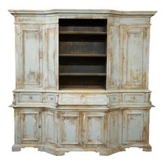 an old white painted cabinet with drawers